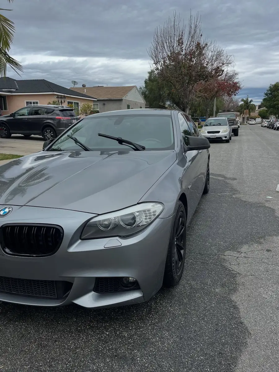 Grey BMW 528i after detailing, parked on a residential street