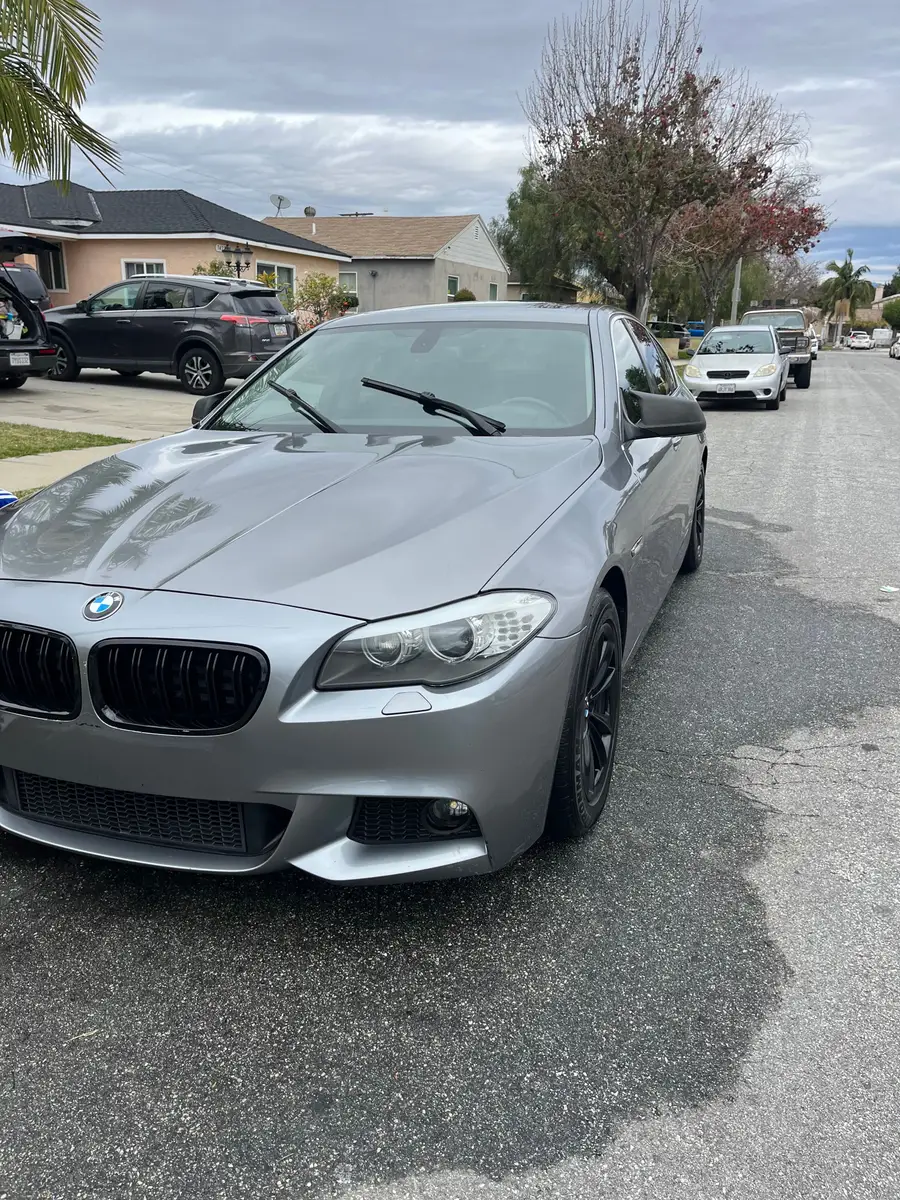 Grey BMW 5 Series after detailing, parked on a residential street