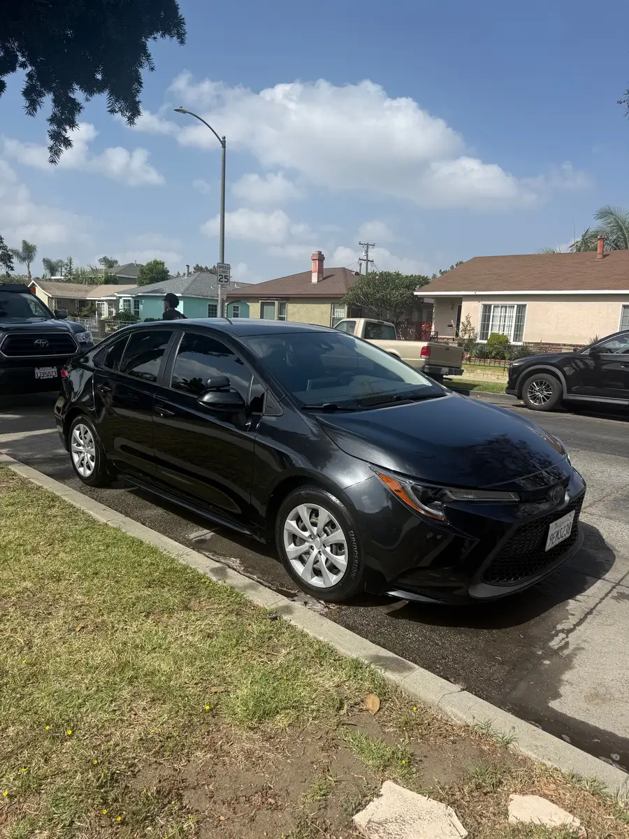 Black Toyota Corolla after detailing, parked at the curb