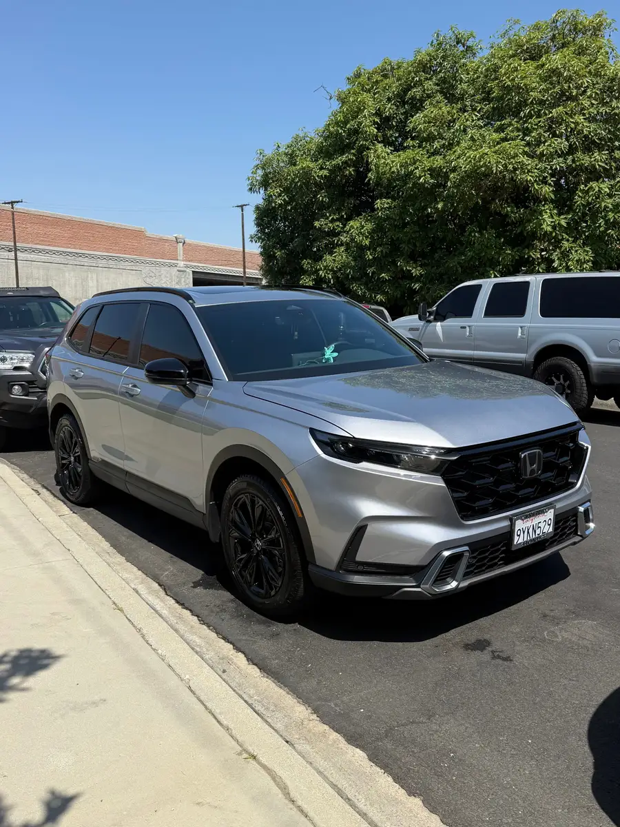 Silver Honda CR-V after detailing, parked at the curb