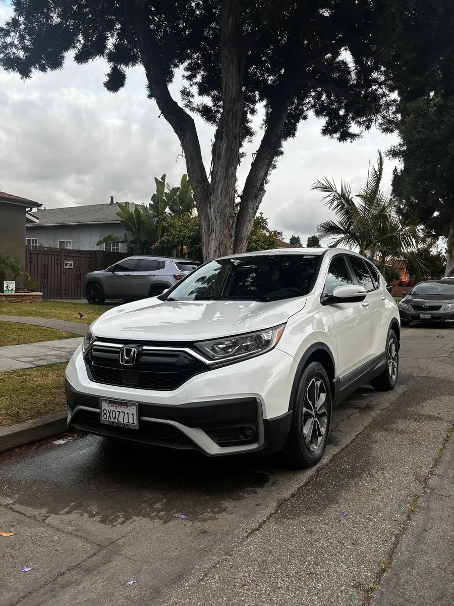 White Honda CR-V after detailing, parked in a driveway