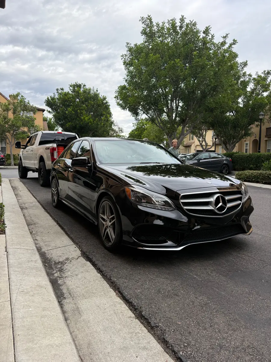 Black Mercedes-Benz E-Class after detailing, parked at the curb