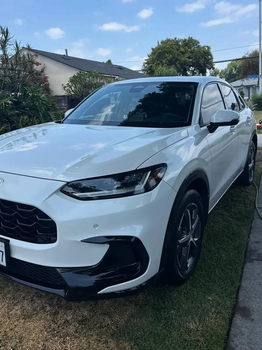 White Honda HR-V after detailing, parked in front of a house