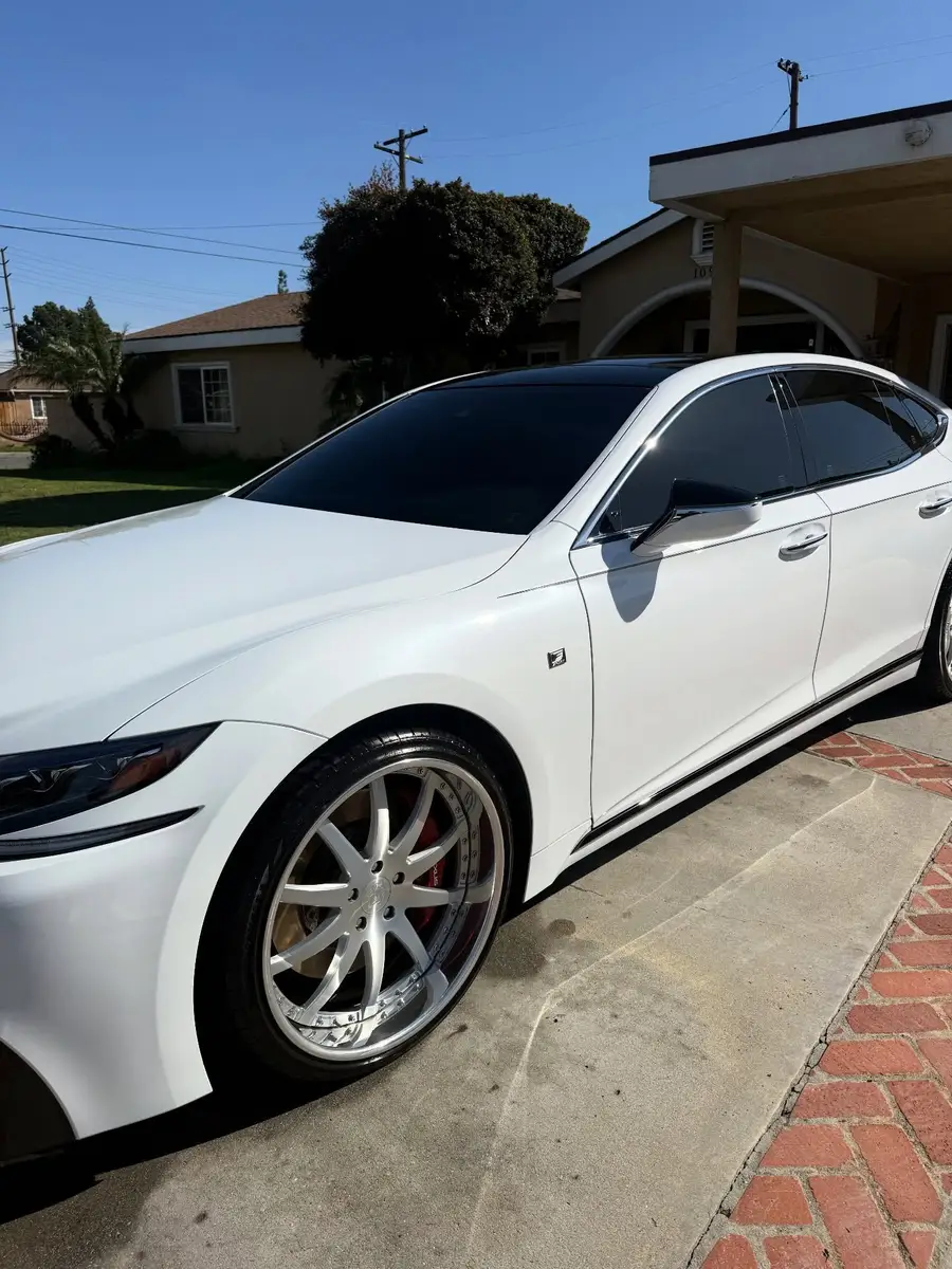 Side of a white Lexus LS 500 F Sport after a detail, parked in a driveway