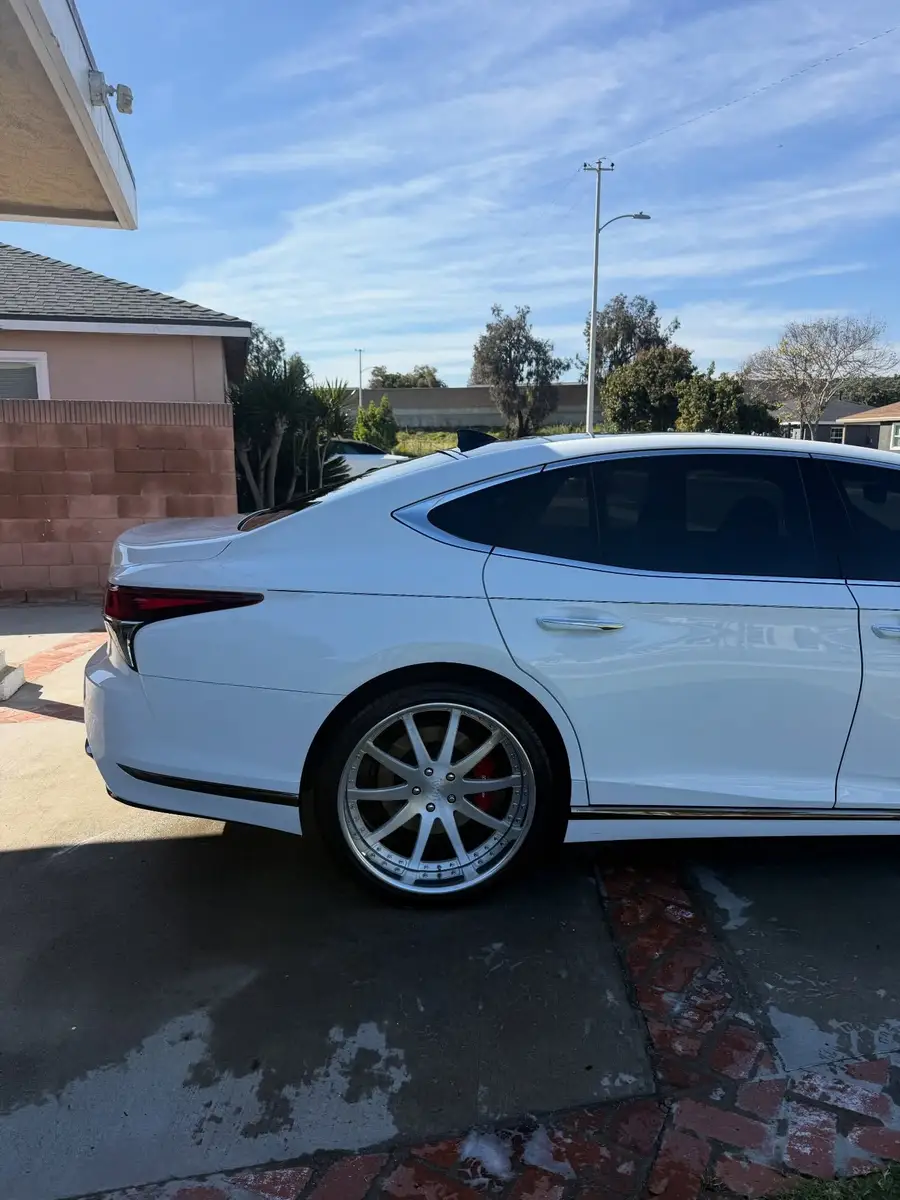 White Lexus LS 500 on a wet driveway after a wash