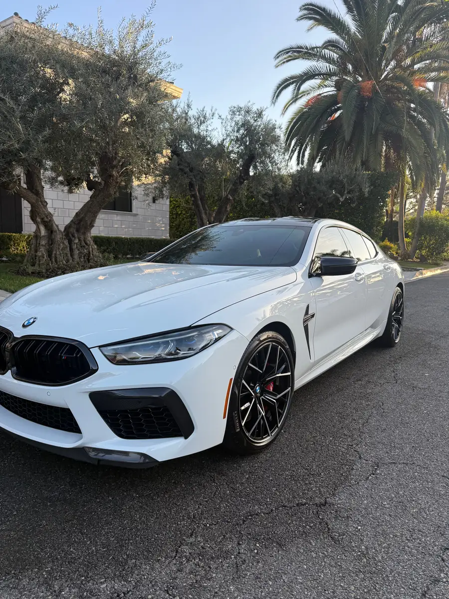 White BMW M8 Gran Coupe after a detail on a Downey street, Dec 2025