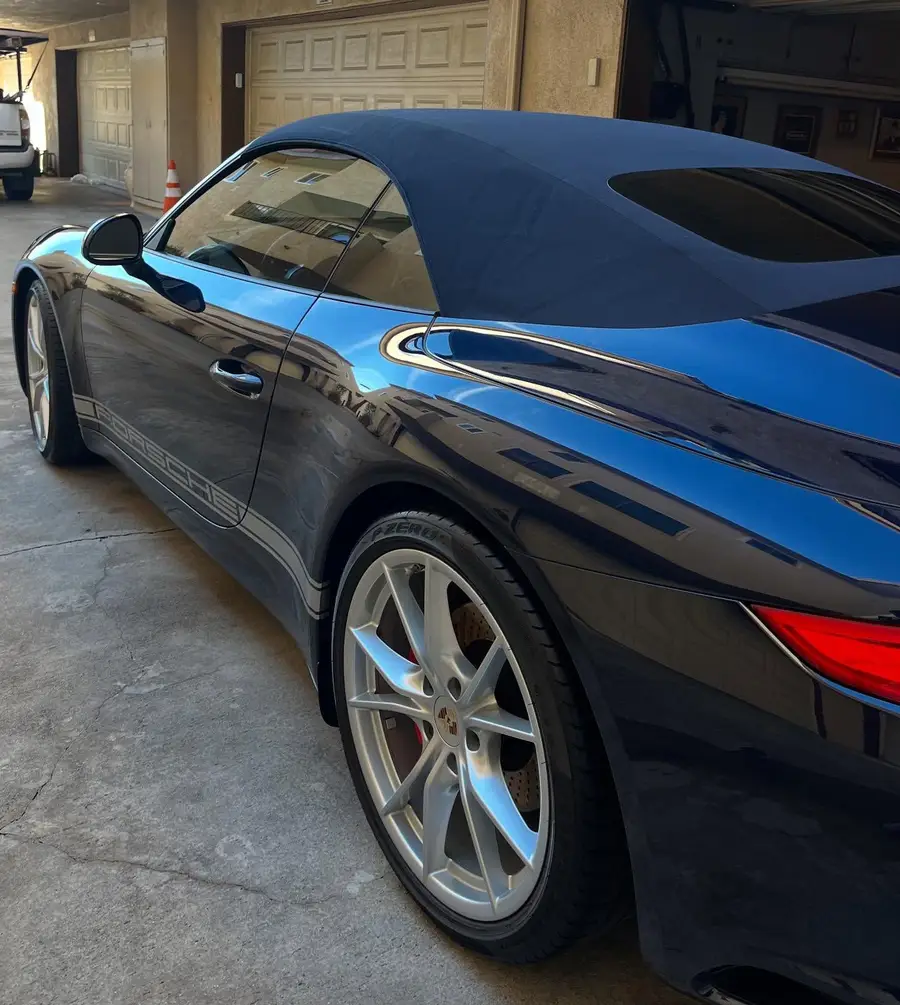 Side of a dark blue Porsche 911 after detailing