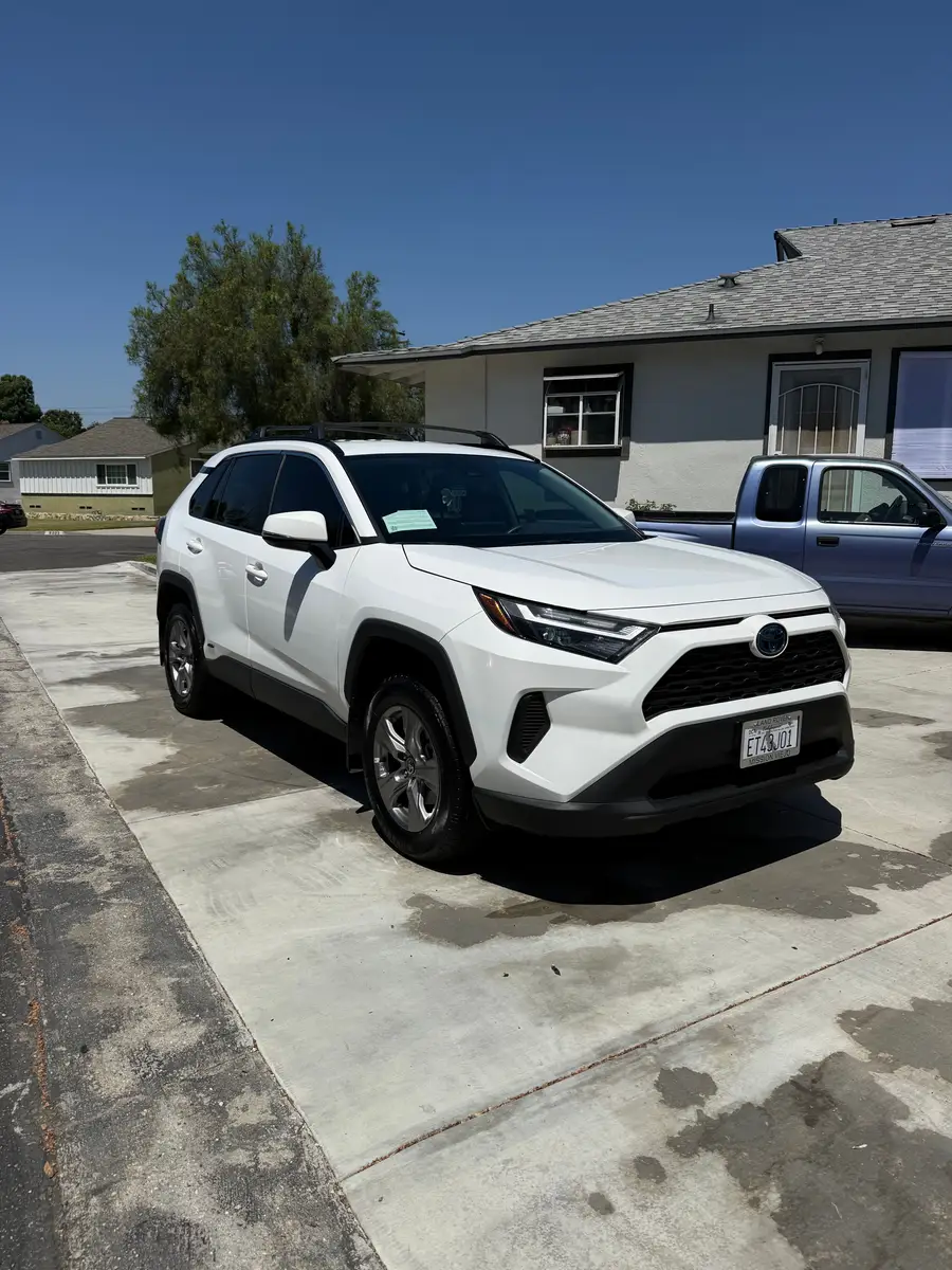 White Toyota RAV4 after detailing, parked in a driveway