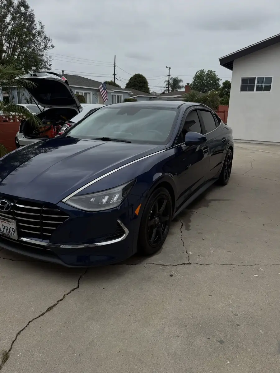 Navy Hyundai Sonata from the front after a detail, in the driveway in front of the garage
