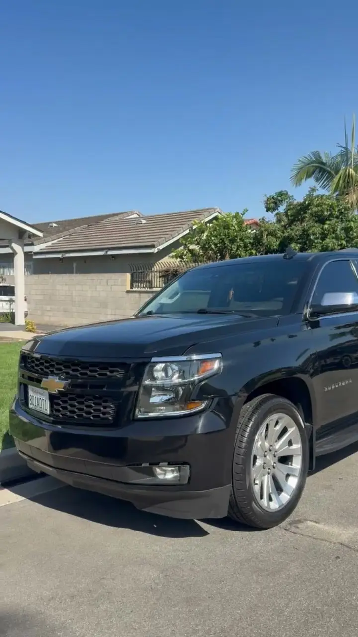 Black Chevrolet Tahoe after detailing, parked on a residential street